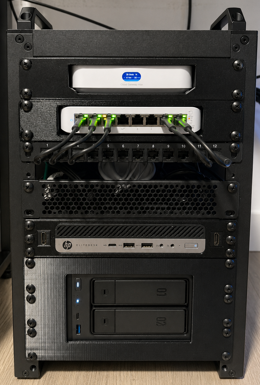 My DeskPi 10-inch rack, built: Cloud Gateway Max, Switch Lite 8 PoE, patch panel, HP EliteDesk running Proxmox, and the UGREEN DXP2800 NAS, stacked top to bottom